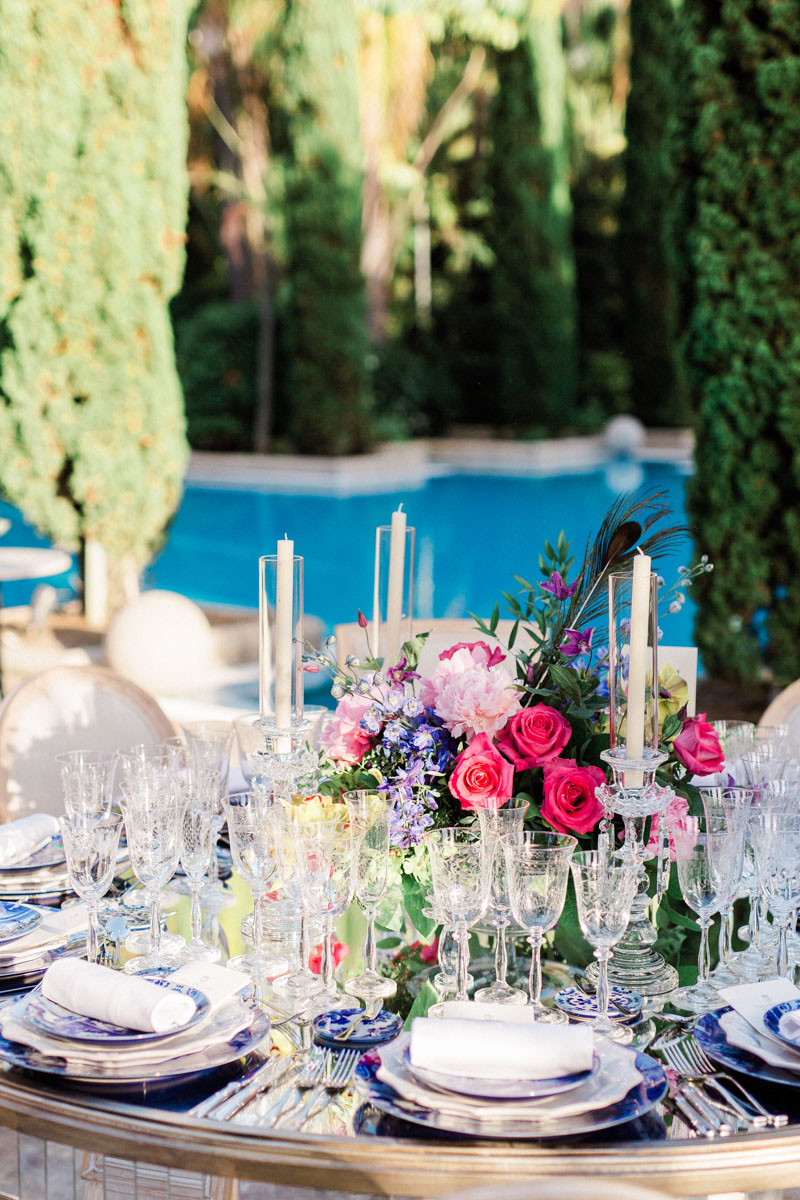 Blue tableware crystal glasses colourful flower arrangements wedding Anantara Villa Padierna