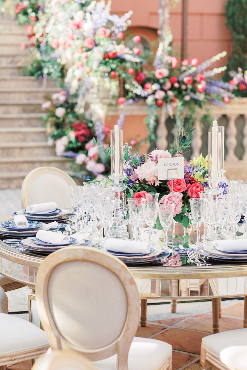 Mirror table Louis XVI chairs bright colour flower arrangements Anantara Villa Padierna
